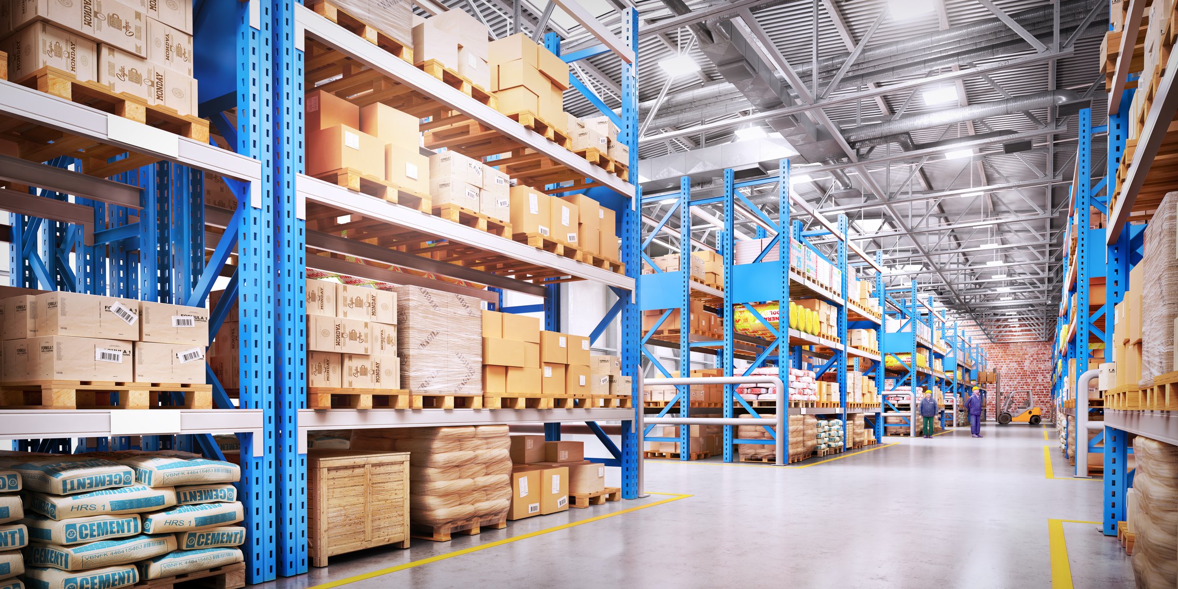Modern high-bay warehouse interior with blue pallet racking three levels high, palletised stock, cement bags, two workers in hi-vis and hard hats walking past a forklift in the distance